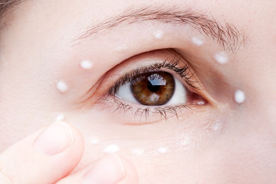 Women Applying Eye Skin Cream