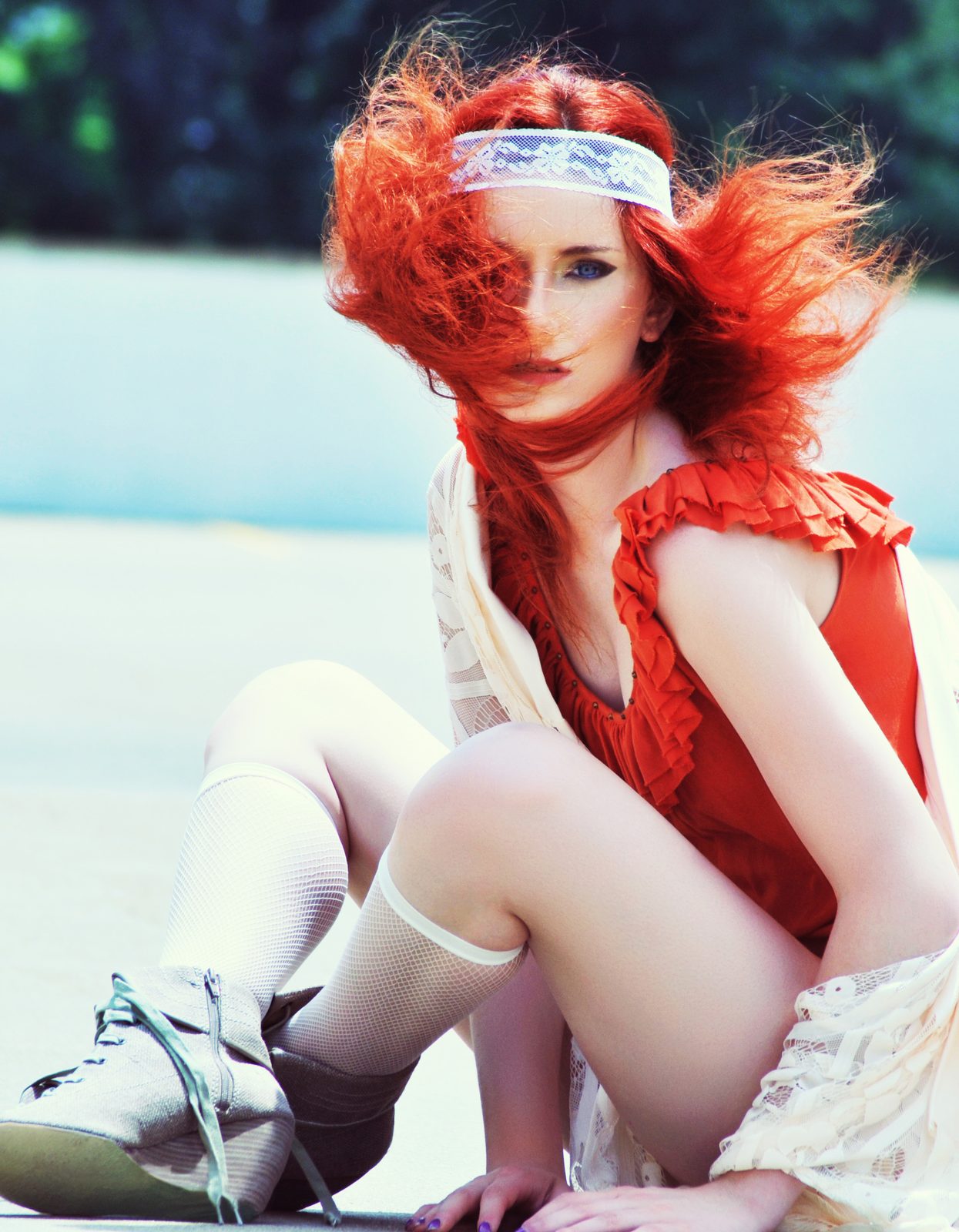 Red-haired model in a red ruffled unitard and lace shawl with a lace headband