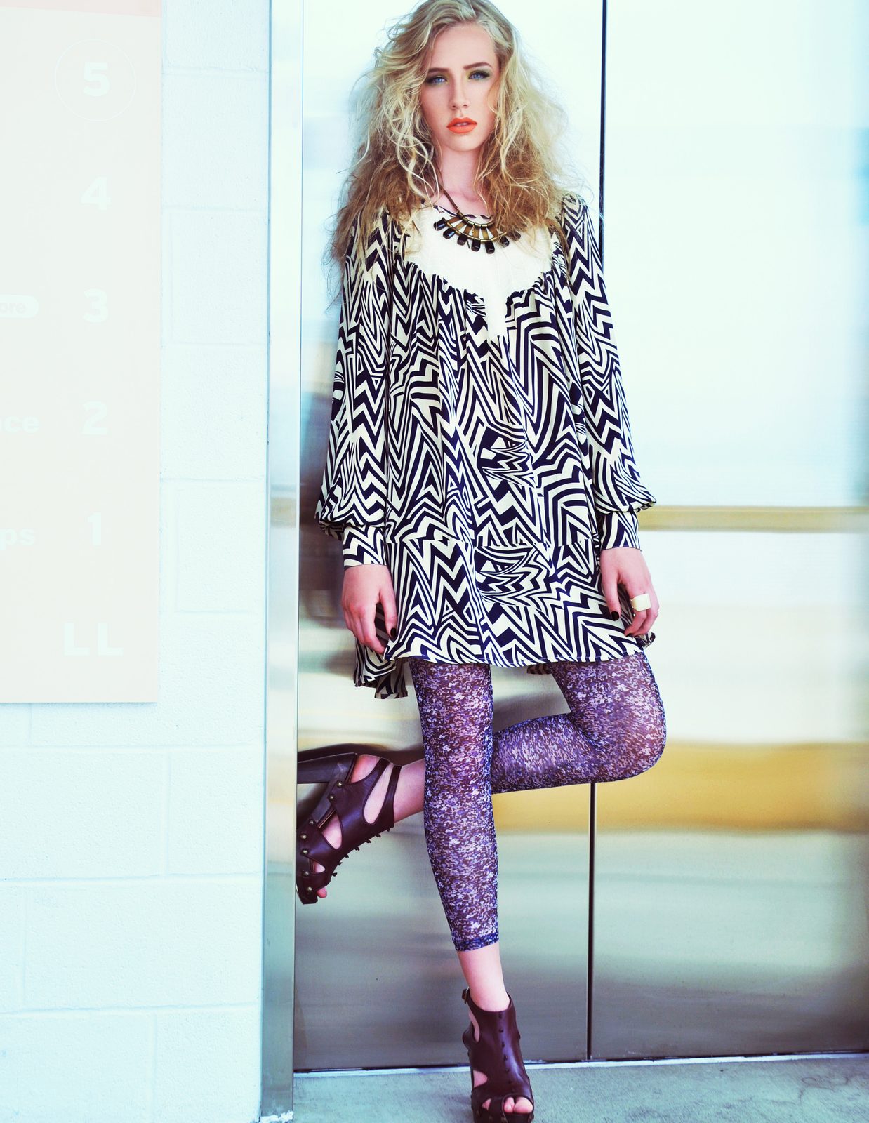 Model in a black and white zebra-print dress over sequined leggings