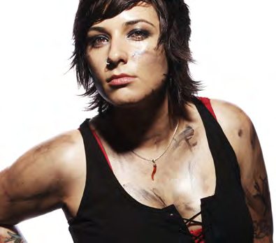 Drummer Laura Petracca in a black lace-up tank top with smudged makeup and a red pendant necklace