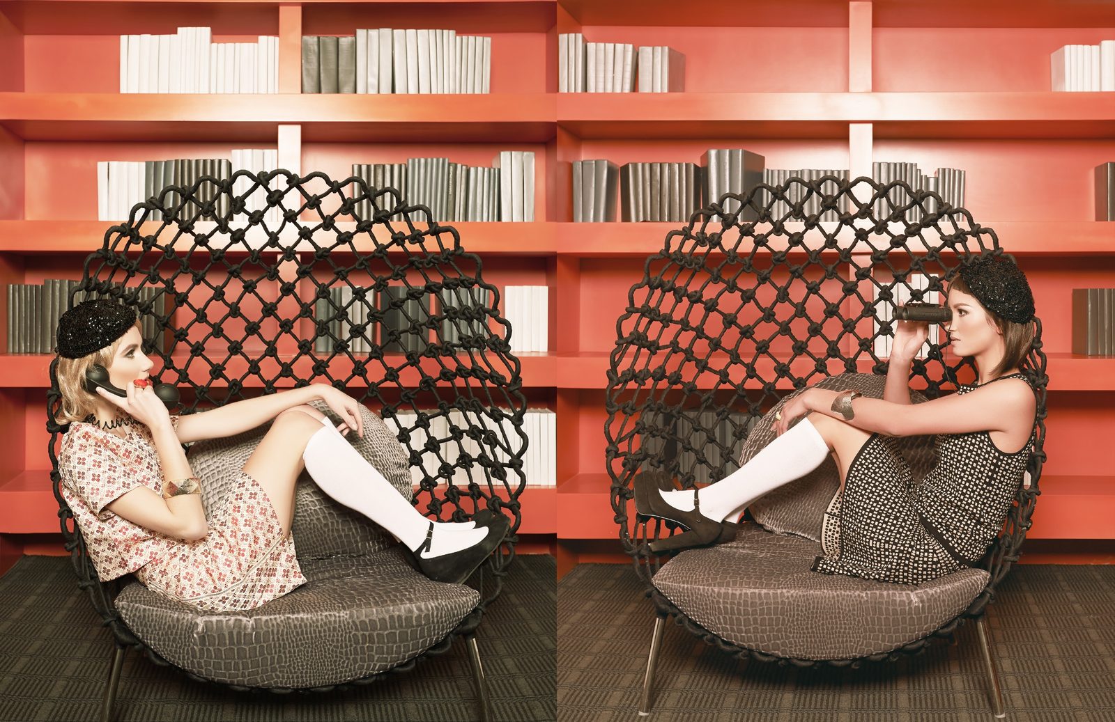 Two models in printed mod dresses and knee socks lounge in woven pod chairs before orange bookshelves